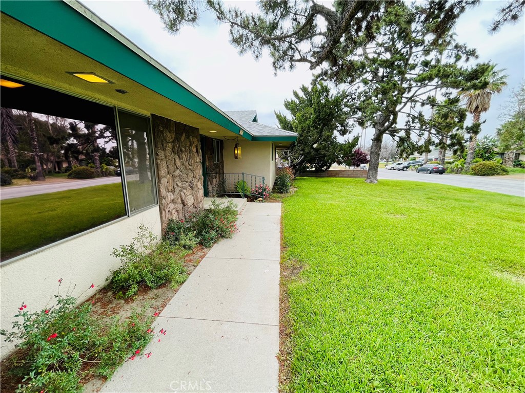 5875 Olive Avenue Rialto, CA 92377 - Photo 13 of 54 a front view of a house with garden