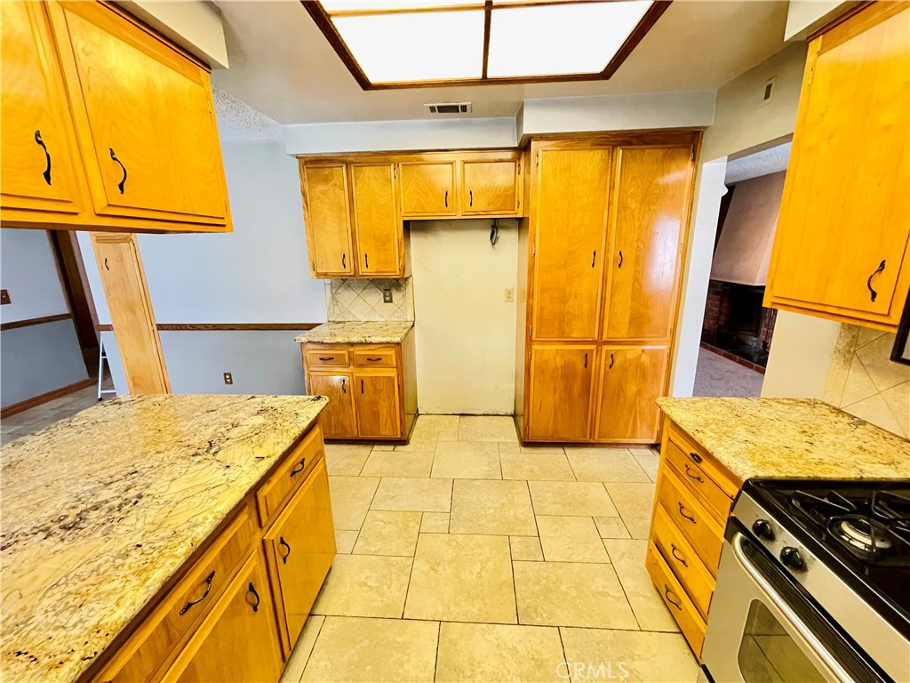 5875 Olive Avenue Rialto, CA 92377 - Photo 27 of 54 a bathroom with a granite countertop sink and a mirror