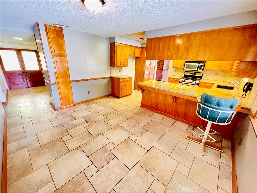 5875 Olive Avenue Rialto, CA 92377 - Photo 29 of 54 a bedroom with a bed and wooden floor