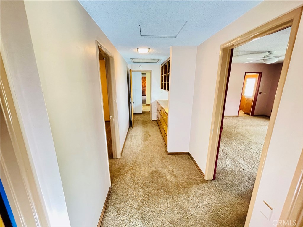 5875 Olive Avenue Rialto, CA 92377 - Photo 33 of 54 a view of a hallway with furniture and front door