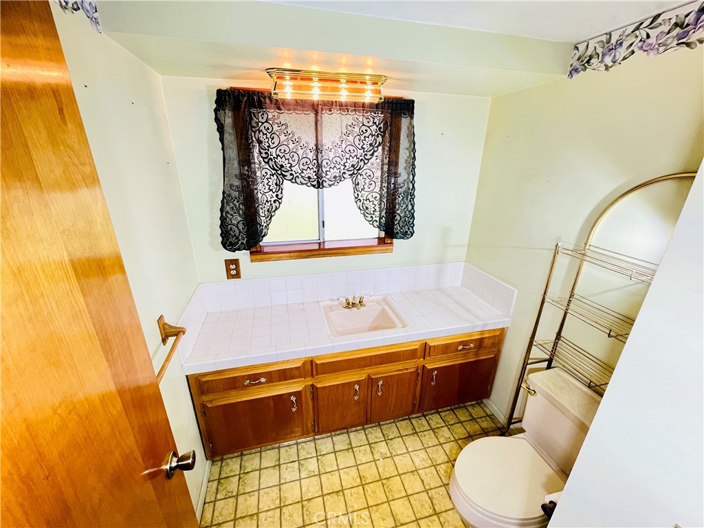 5875 Olive Avenue Rialto, CA 92377 - Photo 35 of 54 a bathroom with a sink and a mirror