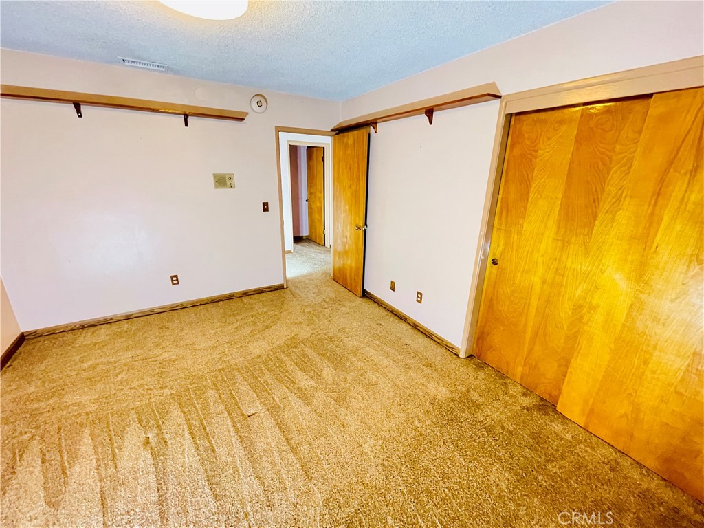 5875 Olive Avenue Rialto, CA 92377 - Photo 37 of 54 a view of a big room with wooden floor and a window