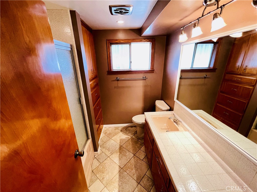 5875 Olive Avenue Rialto, CA 92377 - Photo 40 of 54 a bed room with a bed and a mirror