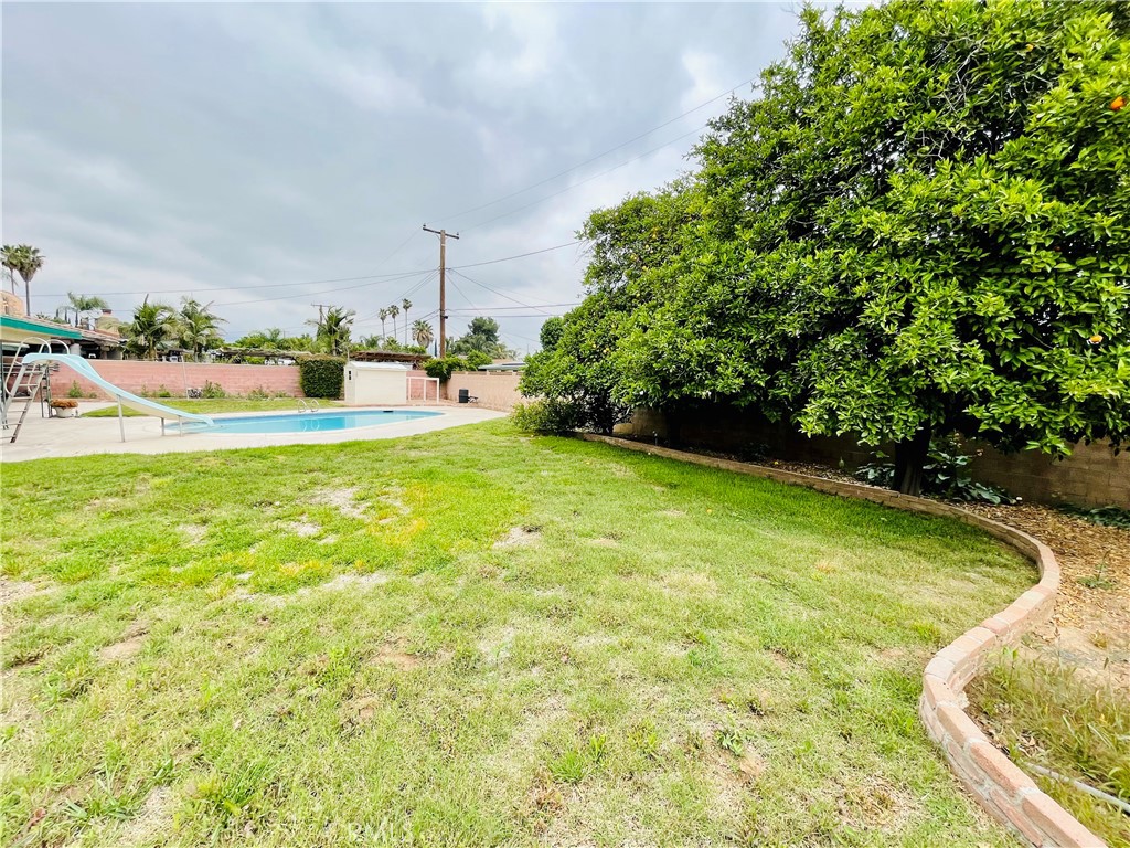 5875 Olive Avenue Rialto, CA 92377 - Photo 49 of 54 a view of a swimming pool and a yard