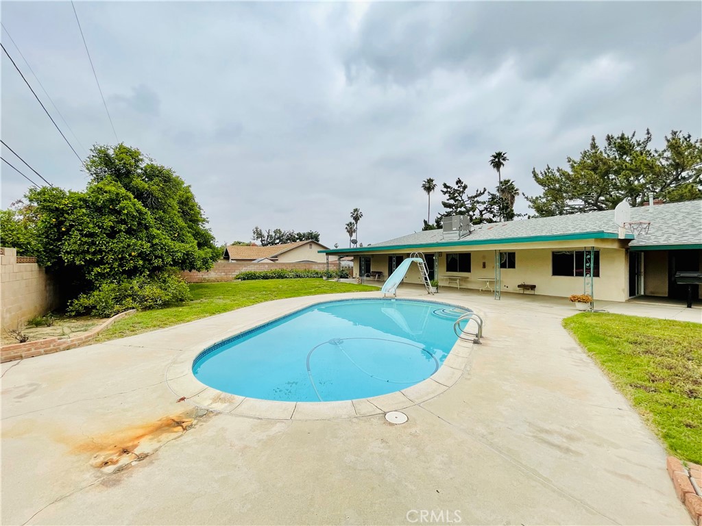 5875 Olive Avenue Rialto, CA 92377 - Photo 52 of 54 a view of a swimming pool with a yard