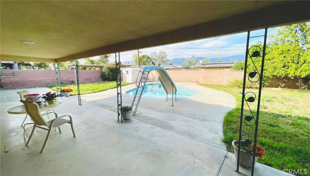 5875 Olive Avenue Rialto, CA 92377 - Photo 6 of 54 a view of a swimming pool with a patio and a garden