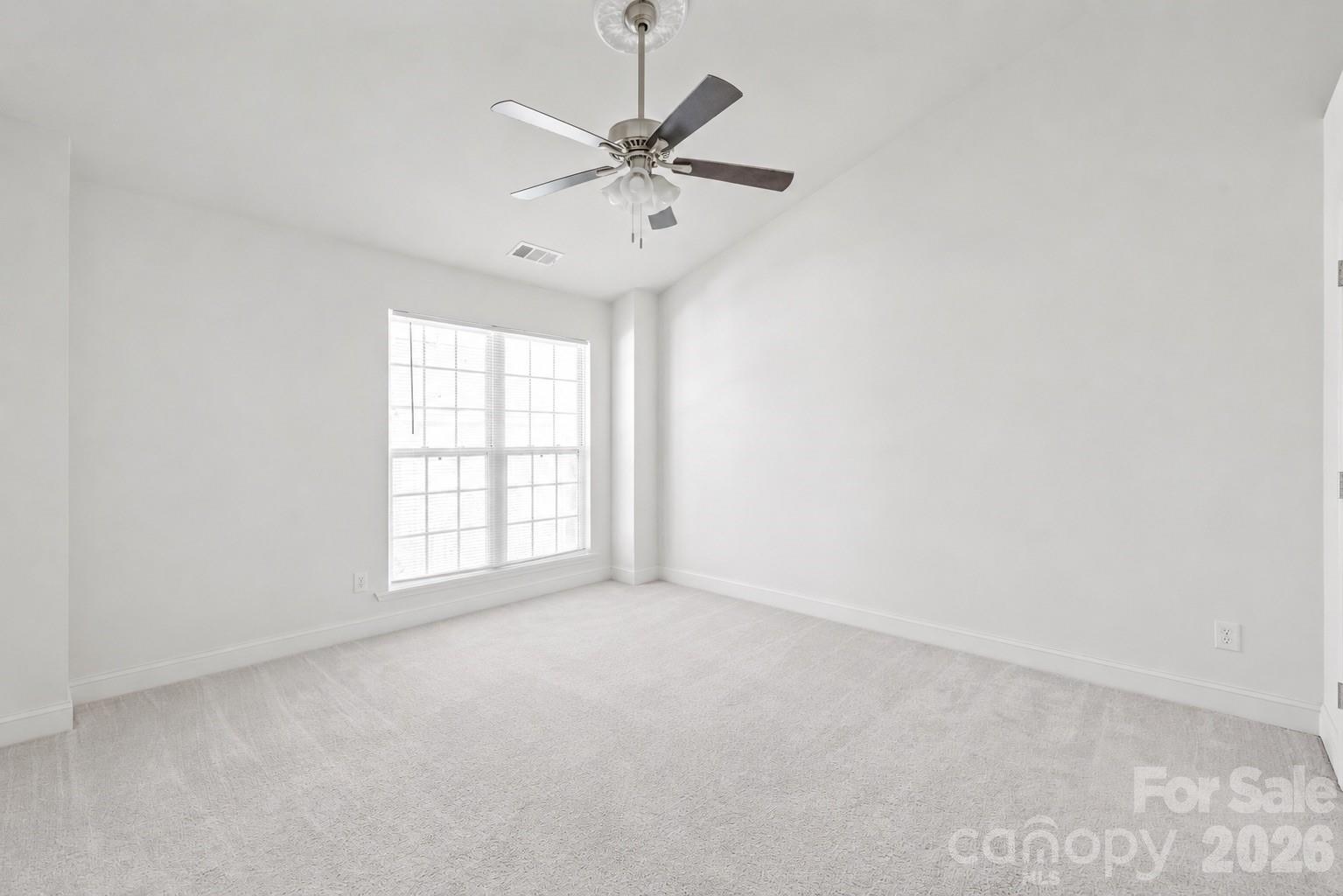 1707 Kashmir White Lane Fort Mill, SC 29708 - Photo 20 of 33 an empty room with a window and a fan