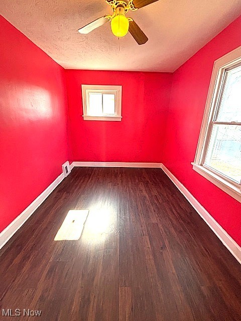 932 Nela View Road Cleveland Heights, OH 44112 - Photo 4 of 8 Spare room with ceiling fan, a textured ceiling, baseboards, and wood finished floors