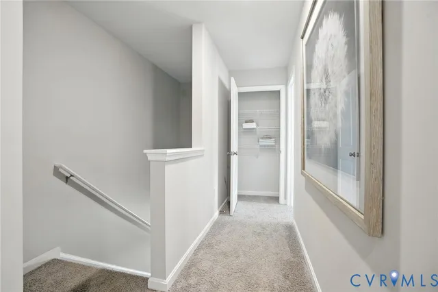 a view of a hallway with wooden floor and entryway