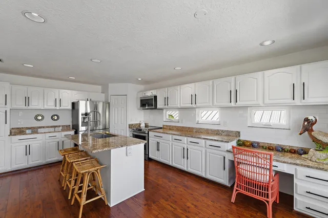 a bedroom with a large bed and a dresser