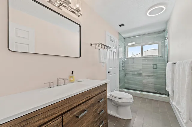 a bedroom with furniture and a wooden floor