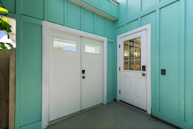 a view of a hallway with wooden floor and entryway