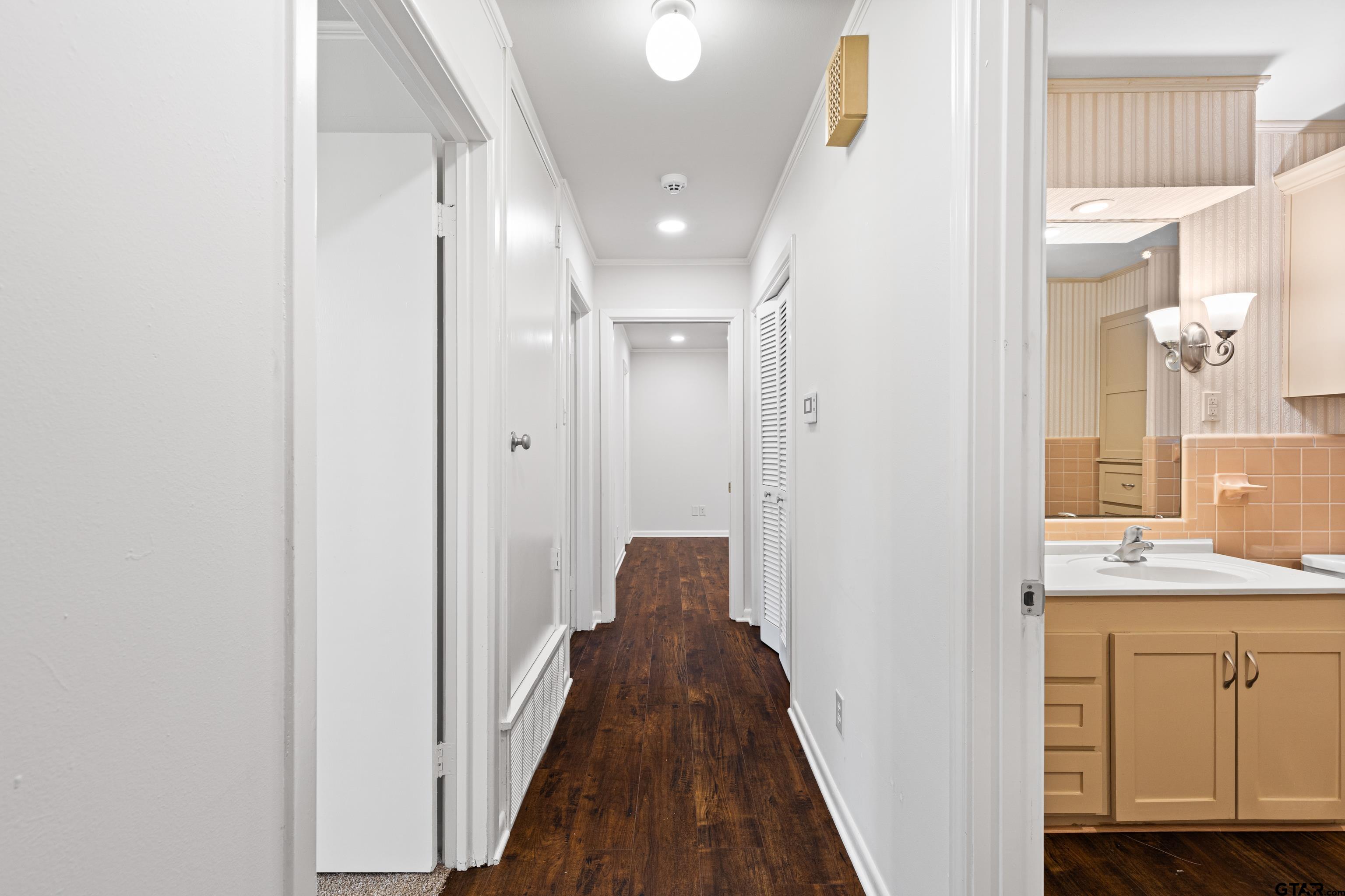 7 Lindsey Lane Longview, TX 75601 - Photo 22 of 36 a view of a hallway with wooden floor and a bathroom