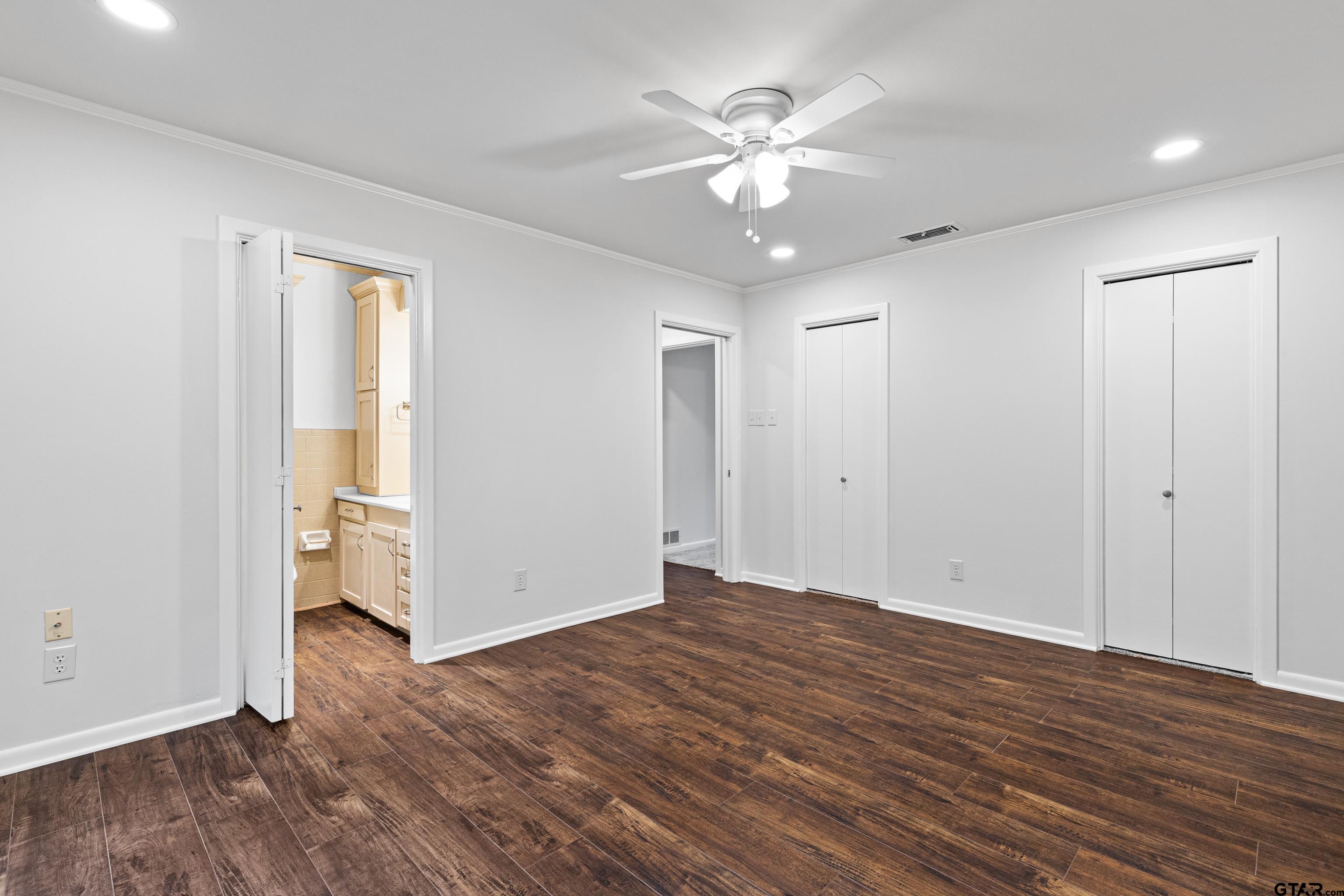 7 Lindsey Lane Longview, TX 75601 - Photo 29 of 36 an empty room with wooden floor and ceiling fan