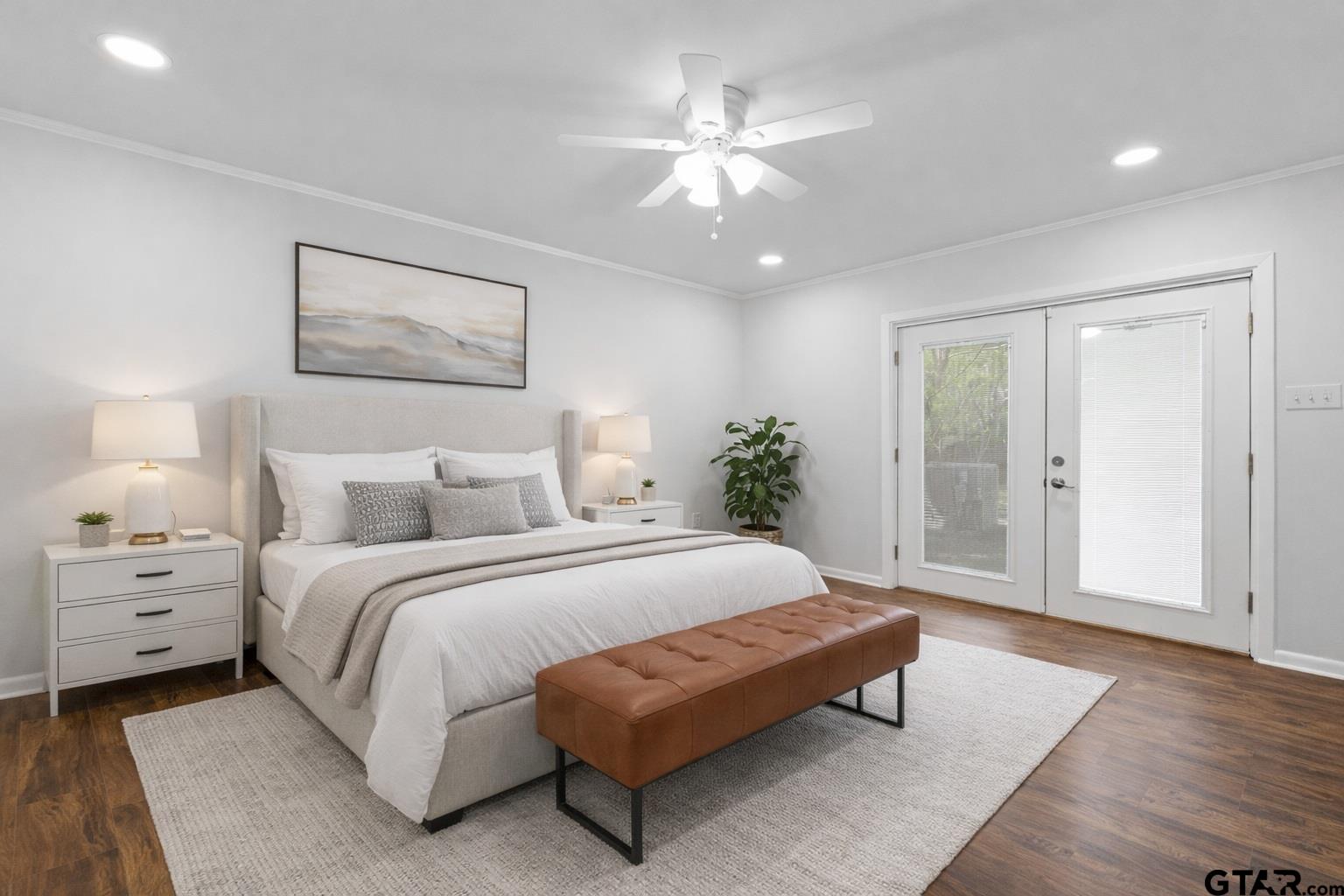 7 Lindsey Lane Longview, TX 75601 - Photo 31 of 36 a spacious bedroom with a bed and a chandelier
