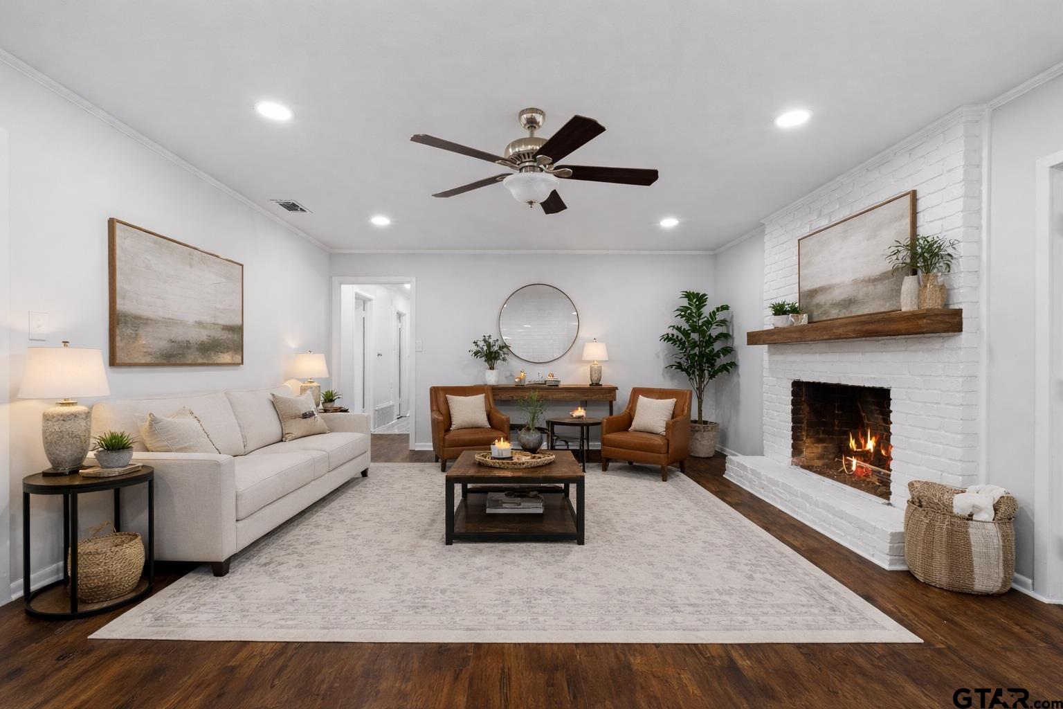 7 Lindsey Lane Longview, TX 75601 - Photo 32 of 36 a living room with furniture a fireplace and a large mirror
