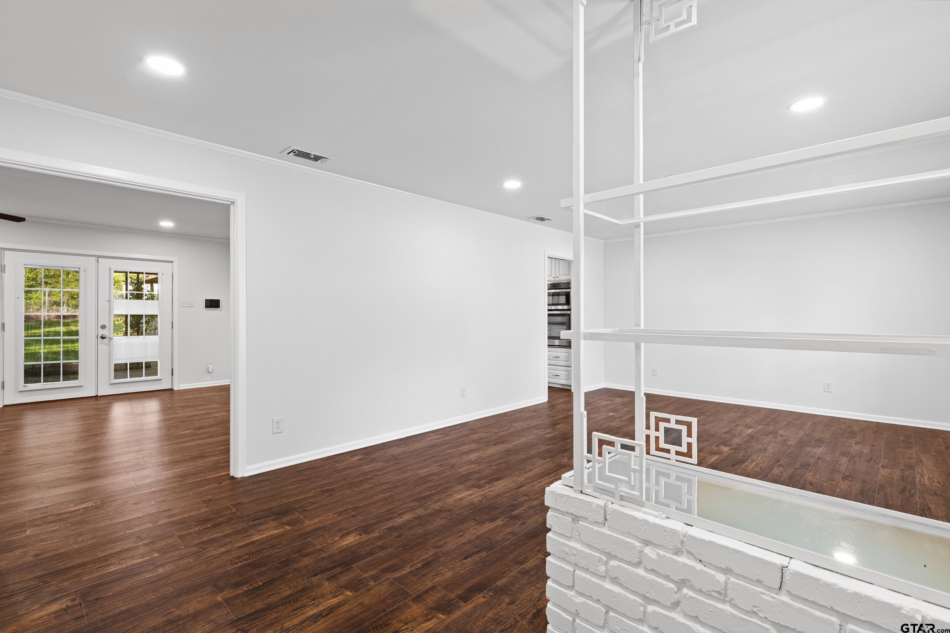 7 Lindsey Lane Longview, TX 75601 - Photo 6 of 36 a room with wooden floor and window