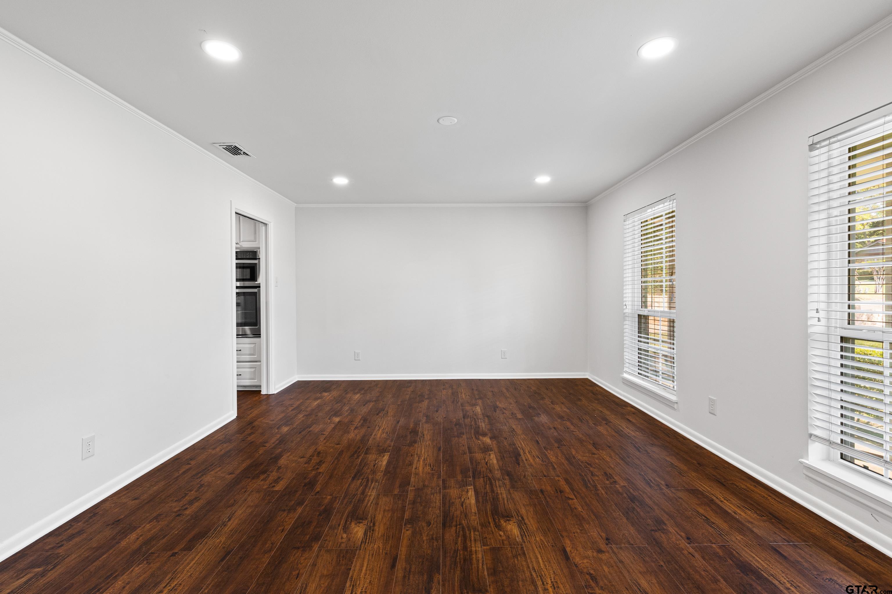 7 Lindsey Lane Longview, TX 75601 - Photo 7 of 36 an empty room with wooden floor and windows