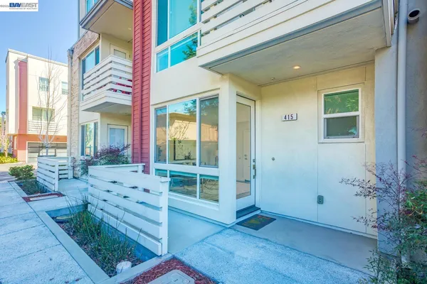 a living room with furniture and a painting on the wall