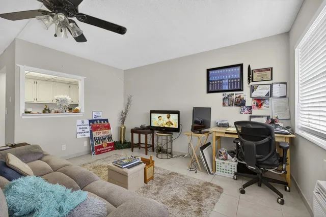 a work room with furniture and a flat screen tv