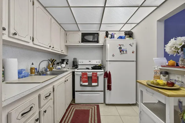 a kitchen with stainless steel appliances granite countertop a refrigerator and a stove