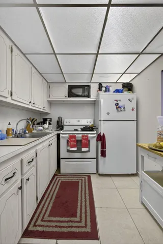 a kitchen with storage and utility