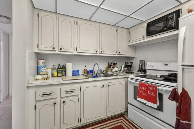 a kitchen with stainless steel appliances granite countertop a sink and cabinets