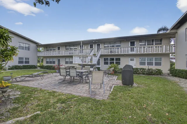 a view of a house with backyard porch and sitting area