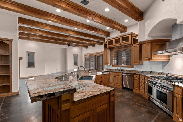2464 East Granite Way St. George, UT 84790 - Photo 54 of 106 Kitchen featuring beam ceiling, light stone countertops, stainless steel appliances, wood finish cabinetry, and concrete floors