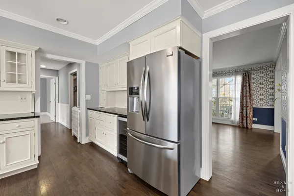 a kitchen with stainless steel appliances a refrigerator and wooden floor