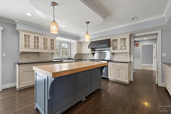 a kitchen with granite countertop a sink cabinets and stainless steel appliances