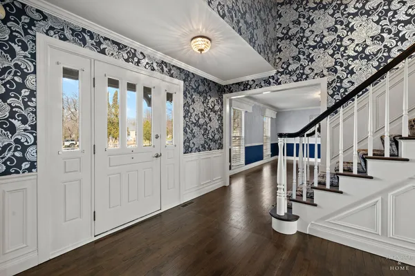 a view of entryway and hall with wooden floor