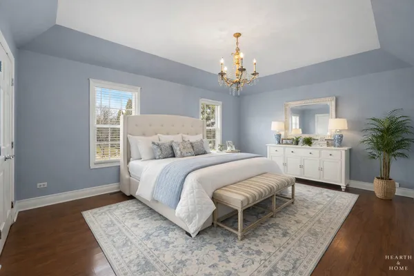 a spacious bedroom with a bed and a chandelier