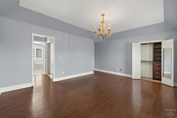 an empty room with wooden floor and window