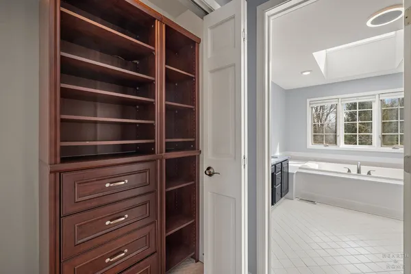 a view of walk in closet and window