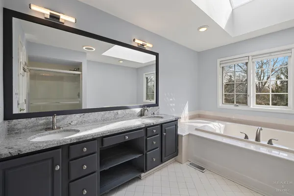 a bathroom with a granite countertop sink mirror and double