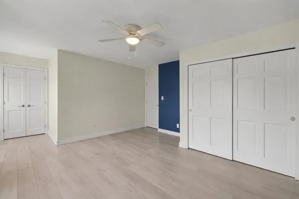 a view of an empty room with a fan