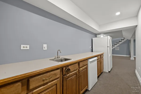 a kitchen with stainless steel appliances a sink and a refrigerator
