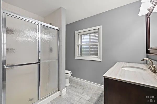 a bathroom with a sink toilet and shower