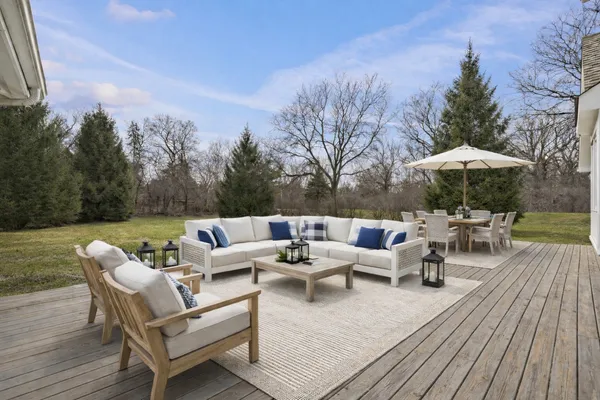 a view of a patio with wooden floor and a yard
