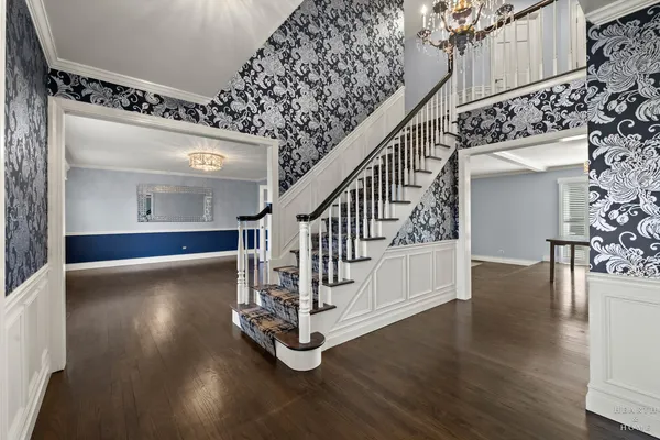 a view of entryway and hall with wooden floor
