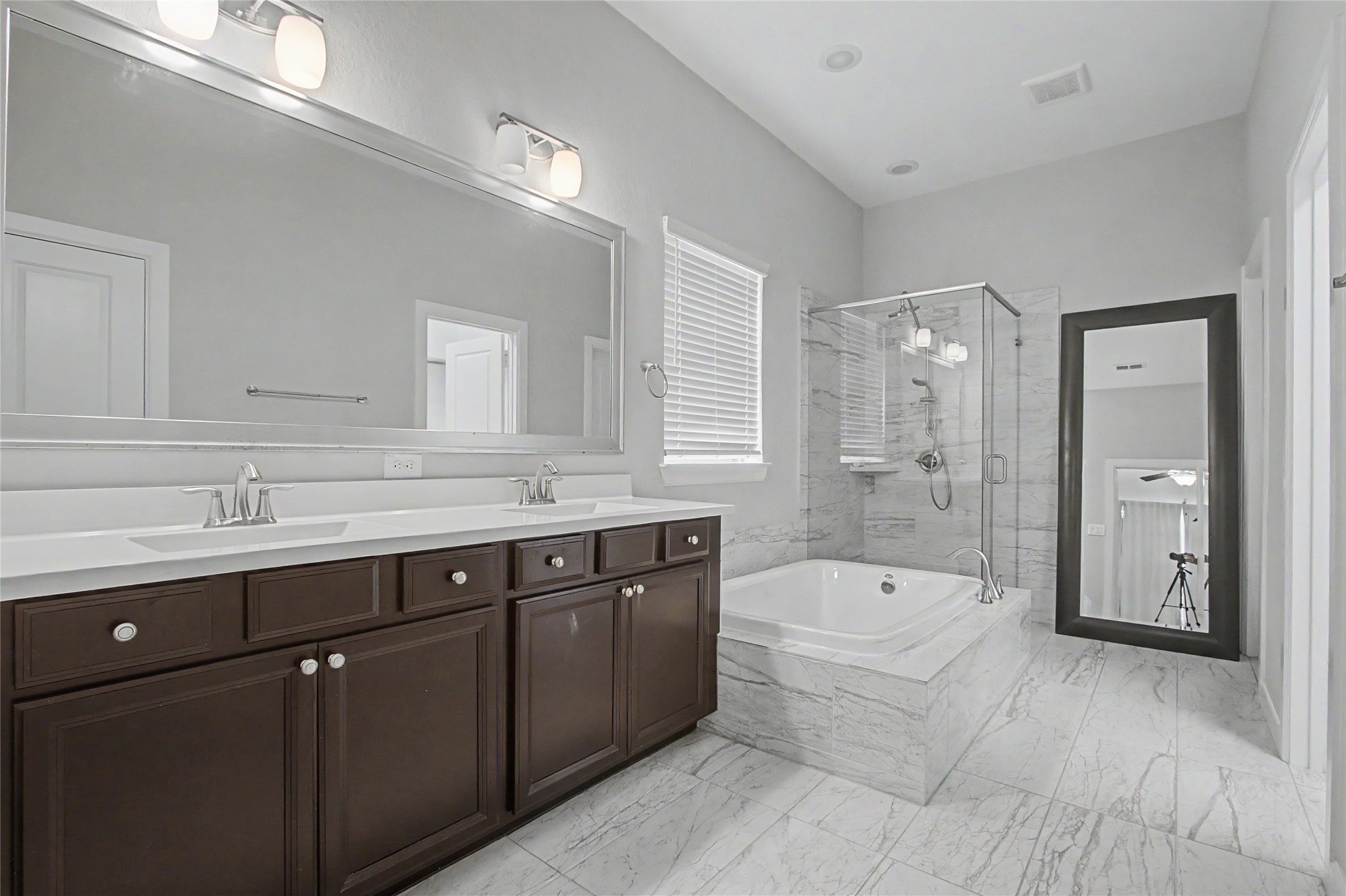 19718 Shinnery Ridge Court Cypress, TX 77433 - Photo 12 of 23 a spacious bathroom with a bathtub shower sink double and mirror