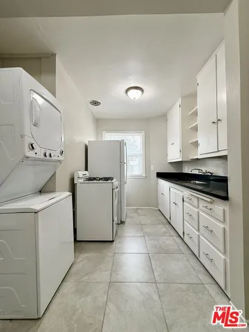 a kitchen with a stove top oven and cabinets