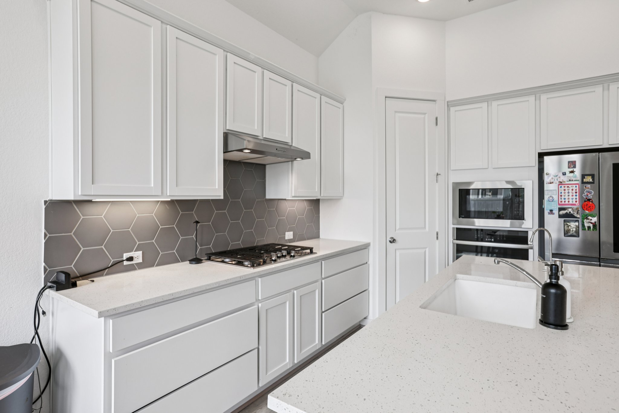 930 Nautical Loop Kyle, TX 78640 - Photo 5 of 25 Gas cooktop, custom tile backsplash, built in oven and microwave