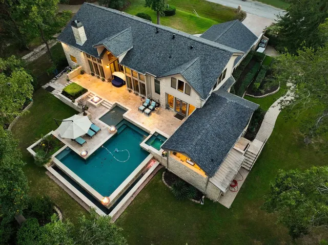 an aerial view of a house with a backyard