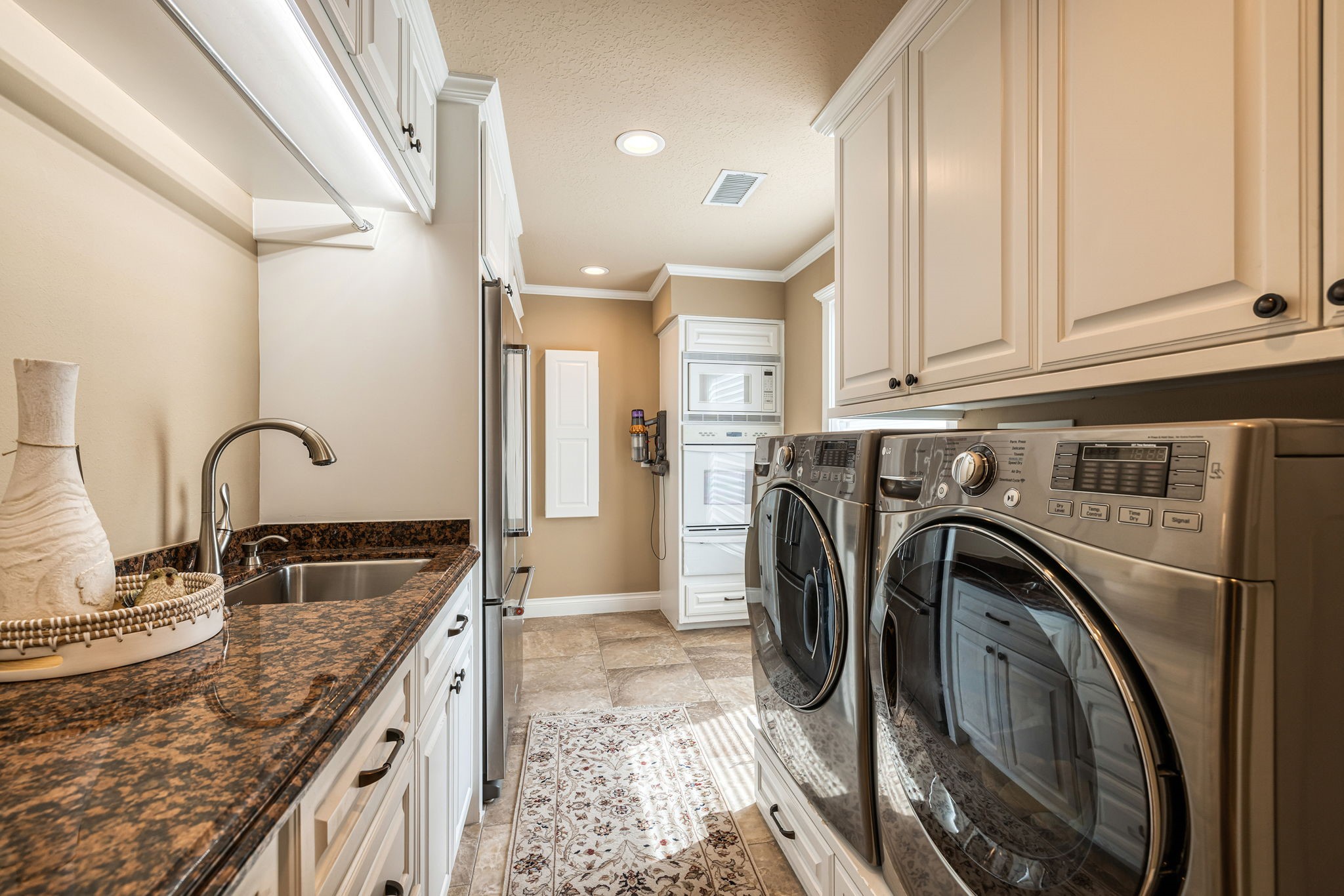 15628 Latson Street Houston, TX 77069 - Photo 20 of 50 a kitchen with kitchen island granite countertop a sink a stove and cabinets