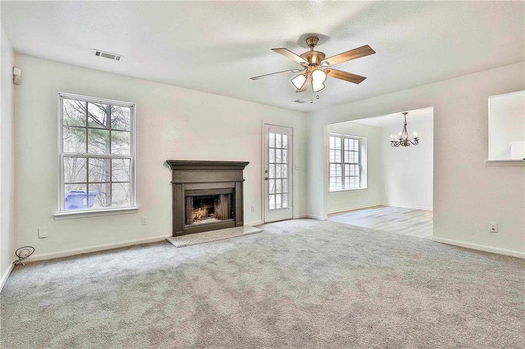 4605 Raven Wood Loop Union City, GA 30291 - Photo 13 of 24 a view of an empty room with a fireplace and a window