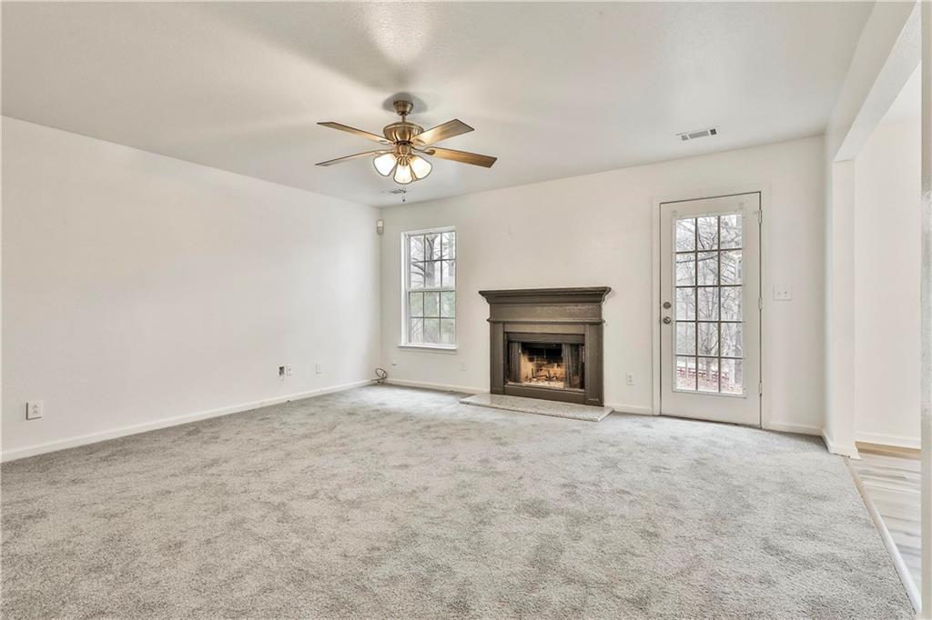 4605 Raven Wood Loop Union City, GA 30291 - Photo 14 of 24 an empty room with windows and fireplace