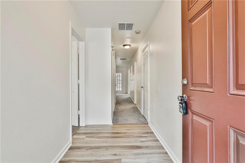 4605 Raven Wood Loop Union City, GA 30291 - Photo 3 of 24 a view of a hallway with wooden floor and staircase