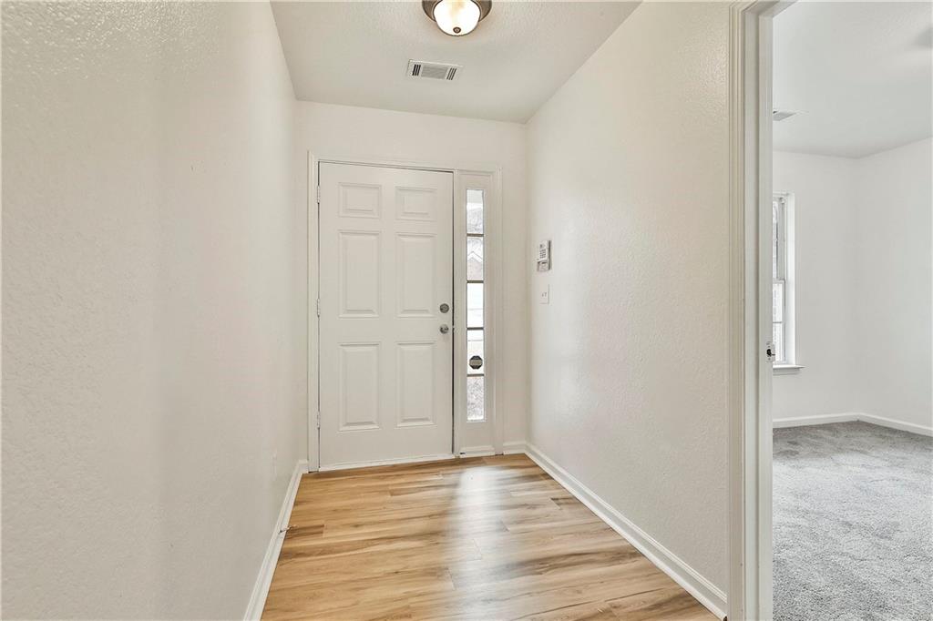 4605 Raven Wood Loop Union City, GA 30291 - Photo 4 of 24 an empty room with wooden floor and windows